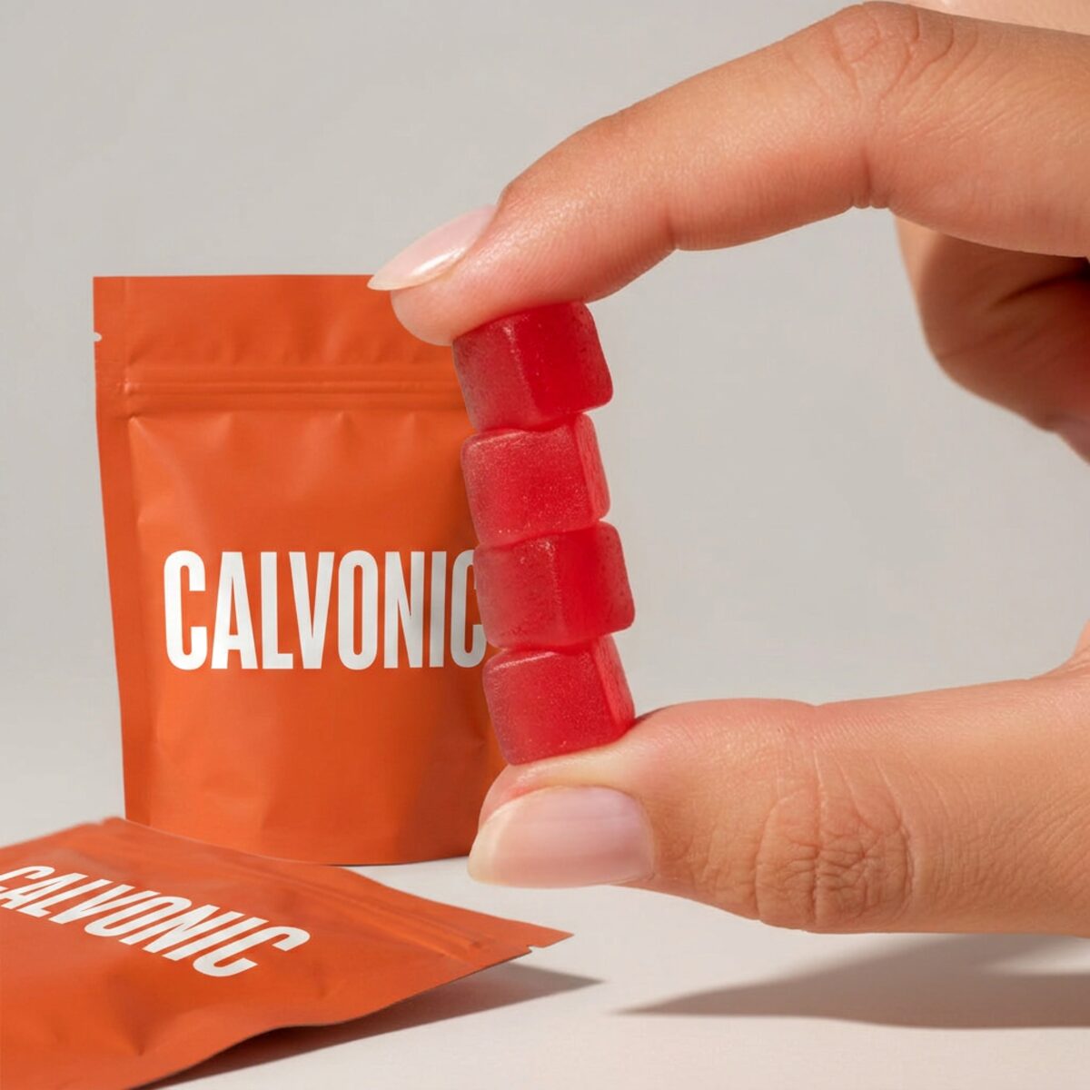 Close-up of four Calvonic watermelon gummies